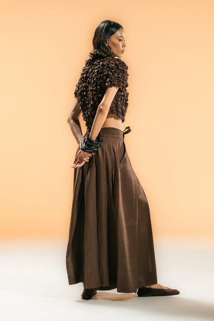 Model wearing Nailah Top in pure cotton, featuring a cropped silhouette with sculpted textured surface and three-dimensional design.