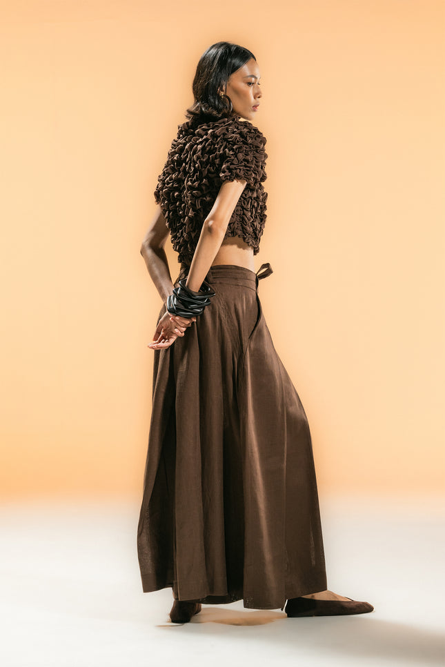 Model wearing Nailah Top in pure cotton, featuring a cropped silhouette with sculpted textured surface and three-dimensional design.
