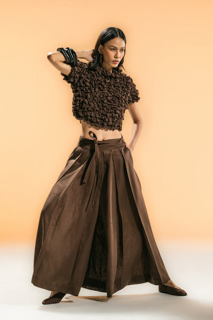 Model wearing Nailah Top in pure cotton, featuring a cropped silhouette with sculpted textured surface and three-dimensional design.