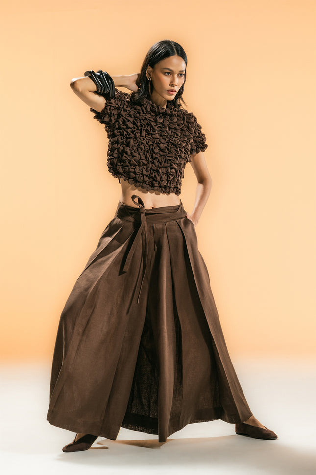 Model wearing Nailah Top in pure cotton, featuring a cropped silhouette with sculpted textured surface and three-dimensional design.