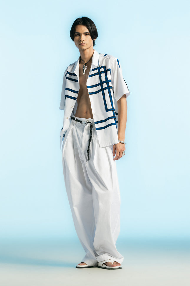 Model wearing Noga Camp Shirt in lightweight cotton, featuring reflected stripe applique, a regular-fit silhouette, and a seamless patch pocket.