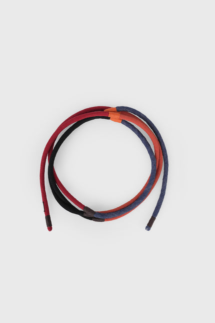Nelu Cord Belt in cotton with a four-color cord design, adjustable one-size fit, and versatile knotting options.