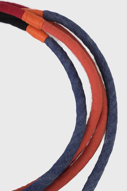 Nelu Cord Belt in cotton with a four-color cord design, adjustable one-size fit, and versatile knotting options.