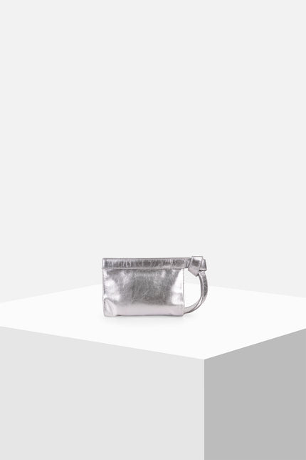 Neri Clutch with a structured rectangular silhouette, cowhide leather exterior, handloom lurik lining, leather patch pocket, double magnetic closure, and knotted strap detail.