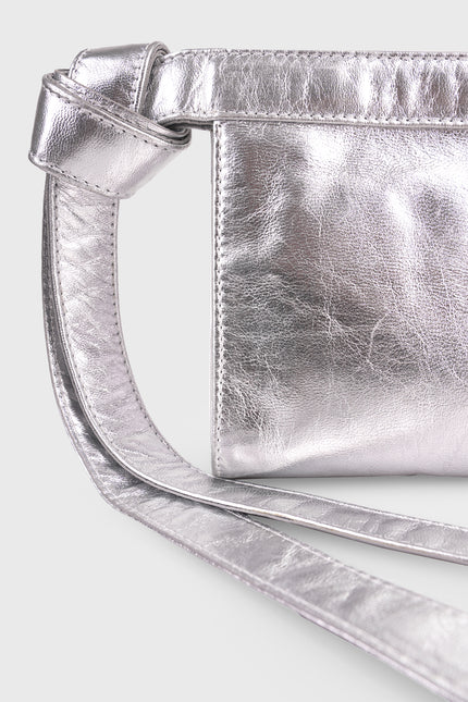 Neri Clutch with a structured rectangular silhouette, cowhide leather exterior, handloom lurik lining, leather patch pocket, double magnetic closure, and knotted strap detail.