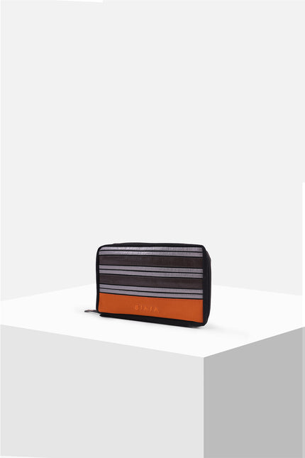 Canvas pouch with bold tarpaulin stripe appliqué, zipper closure, contrast handle, and internal mesh pocket.