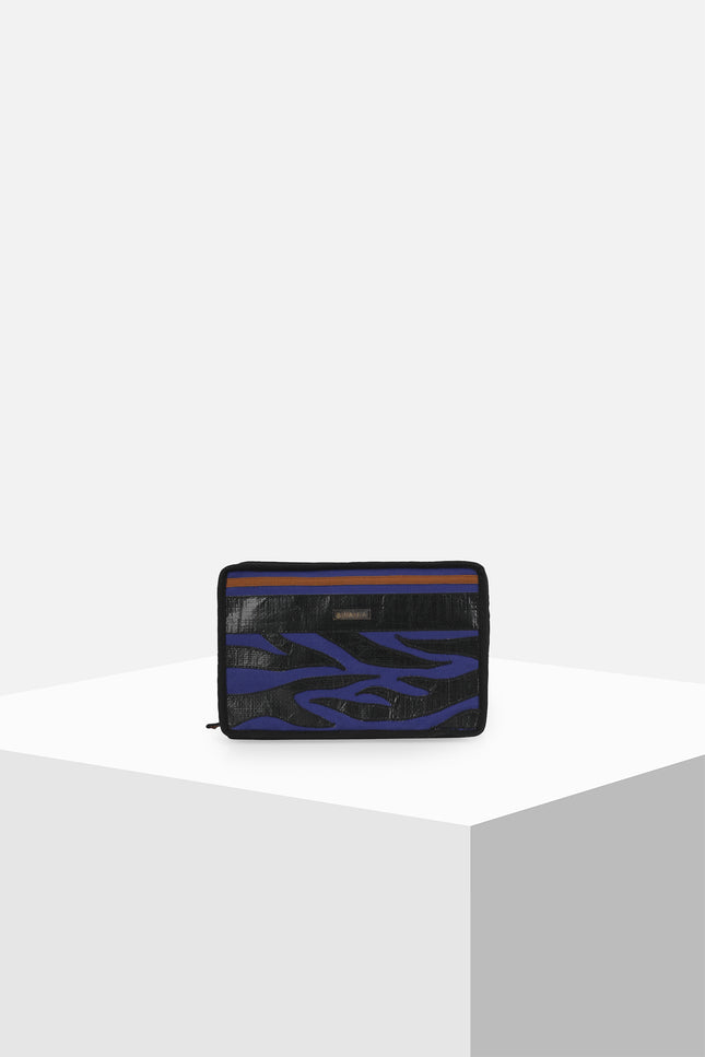 Canvas clutch featuring zebra tarpaulin appliqué, zipper closure, contrast handle, and internal mesh pocket.