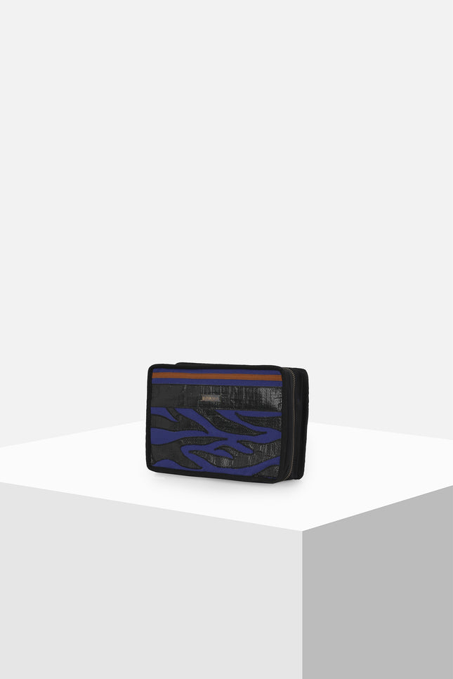 Canvas clutch featuring zebra tarpaulin appliqué, zipper closure, contrast handle, and internal mesh pocket.