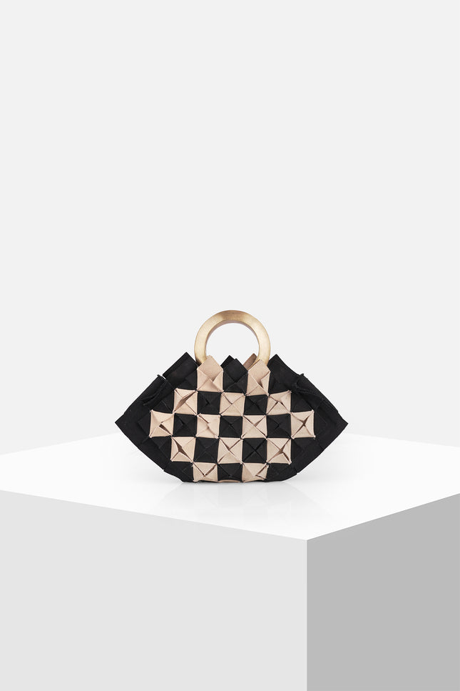 Nerium Mini Handbag with a sculptural hexagonal silhouette, origami-inspired textured cotton body, and handmade brass gold plate handle.