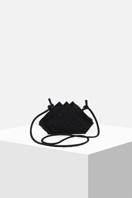 Nemesia Mini Sling Bag made from cotton with origami-inspired geo flower appliqué, featuring a detachable spaghetti strap for crossbody or handheld use.