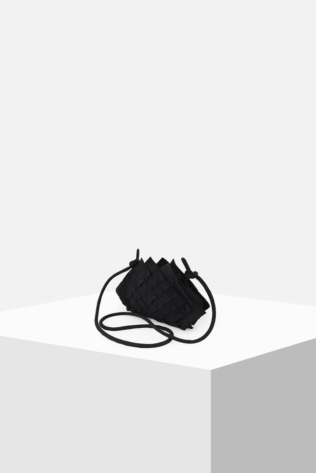 Nemesia Mini Sling Bag made from cotton with origami-inspired geo flower appliqué, featuring a detachable spaghetti strap for crossbody or handheld use.