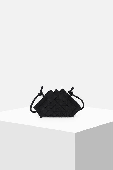 Nemesia Mini Sling Bag made from cotton with origami-inspired geo flower appliqué, featuring a detachable spaghetti strap for crossbody or handheld use.