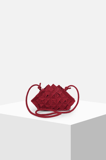 Nemesia Mini Sling Bag made from cotton with origami-inspired geo flower appliqué, featuring a detachable spaghetti strap for crossbody or handheld use.