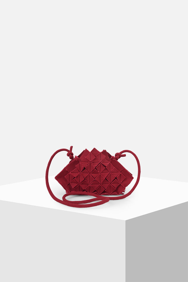 Nemesia Mini Sling Bag made from cotton with origami-inspired geo flower appliqué, featuring a detachable spaghetti strap for crossbody or handheld use.