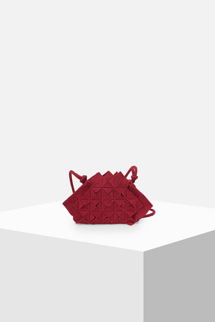 Nemesia Mini Sling Bag made from cotton with origami-inspired geo flower appliqué, featuring a detachable spaghetti strap for crossbody or handheld use.