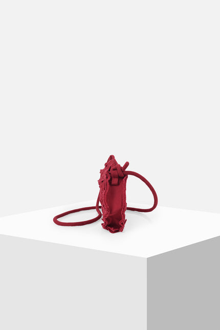 Nemesia Mini Sling Bag made from cotton with origami-inspired geo flower appliqué, featuring a detachable spaghetti strap for crossbody or handheld use.