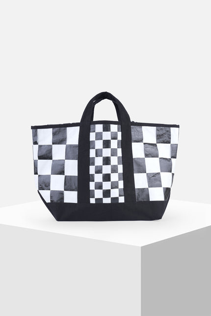 Black and white checkered terpal tote bag with canvas straps, cotton block print accent, and internal pocket.