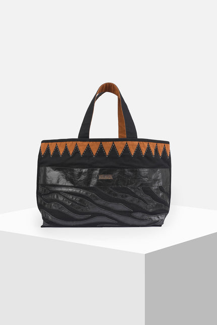Mascha Tote Bag made from durable canvas with contrast lining, featuring triangle appliqué, hand-stitch details, and a zebra-patterned motif in repurposed Terpal, designed with an internal pomet for everyday use.