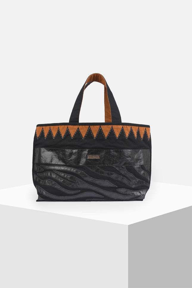 Mascha Tote Bag made from durable canvas with contrast lining, featuring triangle appliqué, hand-stitch details, and a zebra-patterned motif in repurposed Terpal, designed with an internal pomet for everyday use.
