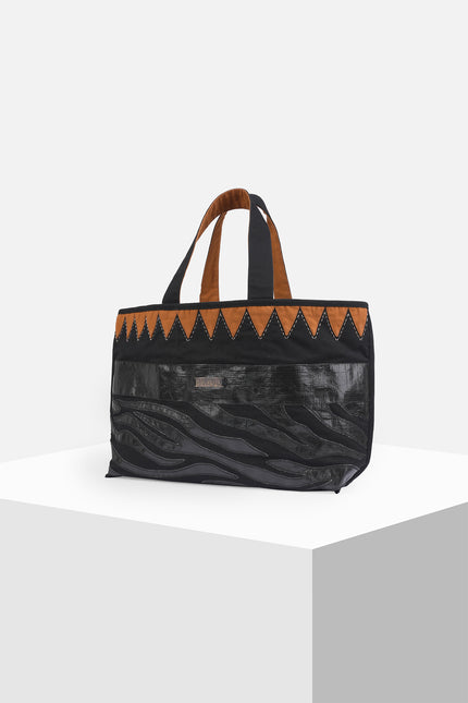 Mascha Tote Bag made from durable canvas with contrast lining, featuring triangle appliqué, hand-stitch details, and a zebra-patterned motif in repurposed Terpal, designed with an internal pomet for everyday use.