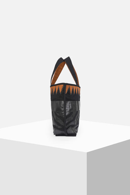 Mascha Tote Bag made from durable canvas with contrast lining, featuring triangle appliqué, hand-stitch details, and a zebra-patterned motif in repurposed Terpal, designed with an internal pomet for everyday use.