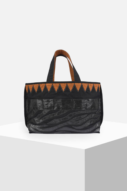 Mascha Tote Bag made from durable canvas with contrast lining, featuring triangle appliqué, hand-stitch details, and a zebra-patterned motif in repurposed Terpal, designed with an internal pomet for everyday use.