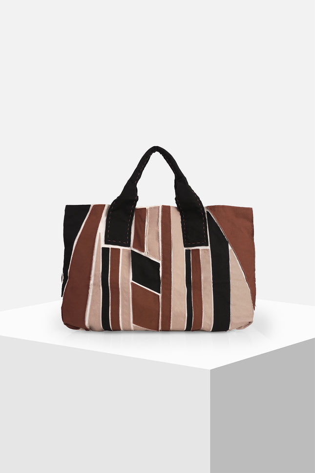 Multicolor cotton canvas tote bag with appliqué panels, contrast hand stitching, and Lagos motif lining.