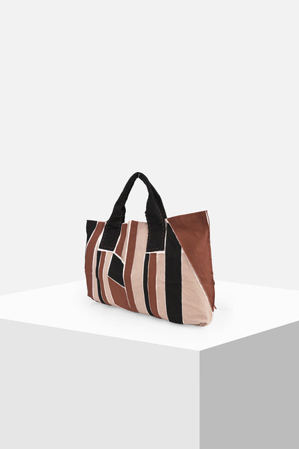 Multicolor cotton canvas tote bag with appliqué panels, contrast hand stitching, and Lagos motif lining.