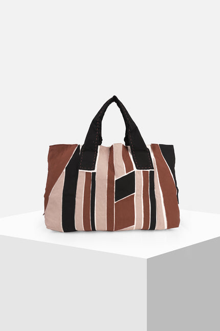 Multicolor cotton canvas tote bag with appliqué panels, contrast hand stitching, and Lagos motif lining.