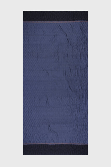 Model wearing a handloom silk sarong in deep indigo, featuring traditional Garut geometric tenun weaving, styled as a draped skirt.