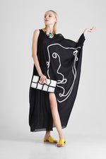 Kaftan with abstract face appliqué and asymmetrical sleeves